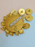 The Artisan brooch in enamel and brass